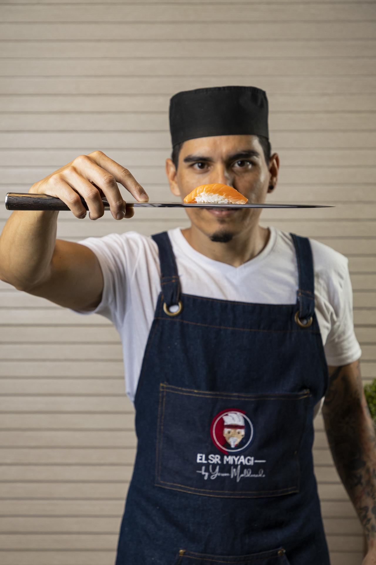 Chef Miyagi mostrando un nigiri sobre un cuchillo